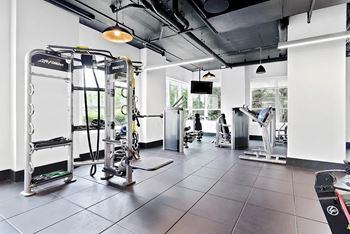 A gym with a variety of equipment including a leg press machine.